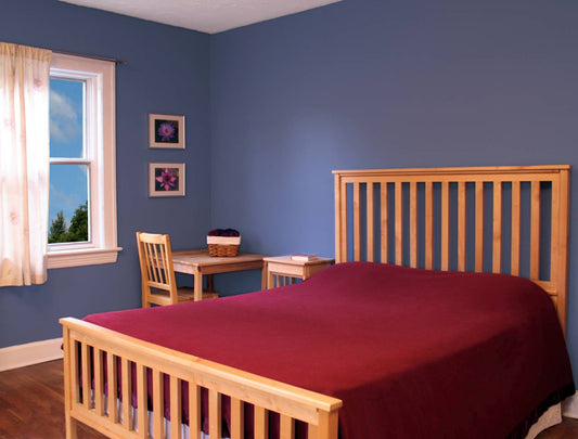 A bedroom with freshly dried blue walls at Complete Paint near Petoskey and Harbor Springs, Michigan