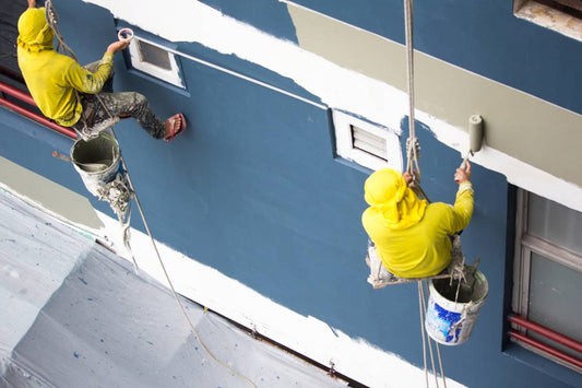 Two commercial contractors painting the exterior of a building near Petoskey and Harbor Springs, Michigan (MI)