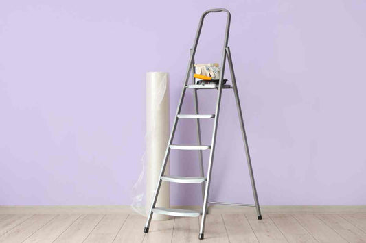 A ladder and painting tools near a lilac wall at Complete Paint near Petoskey, Michigan (MI)